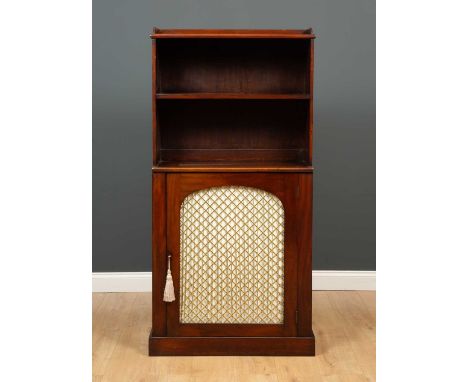 A Regency mahogany bookcase cabinet with a galleried top and fixed shelf above a brass mesh door, raised on a plinth base, 76