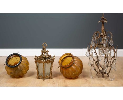 A ceiling light with curved scrolling frame and attached hanging glass drops, 56cm high together with a brass frame and frost