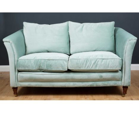 A modern blue upholstered two-seater sofa, the velvet feel upholstery on wooden turned castors, 172cm wide x 88cm deepConditi