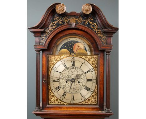 A George III mahogany eight day longcase clock with a breakarch pediment above a brass and silvered dial having a painted sun