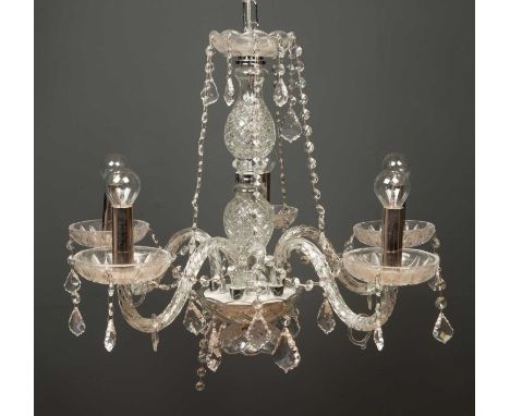 A modern five branch cut glass chandelier with chrome fittings, with a layer of drop pendants around each candle light and ar