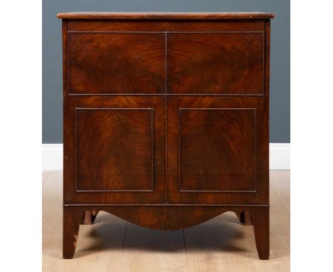 A George III mahogany commode cabinet or chest with lifting hinge lid and turned cover to the seat within, with cockbeaded de