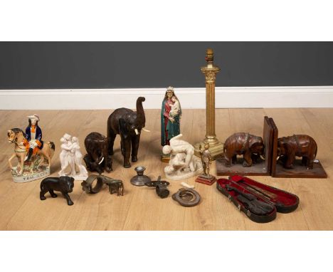 A pair of African rosewood bookends, with elephant mounts, 20cm wide x 15cm deep x 19cm high; a further hardwood figure of an