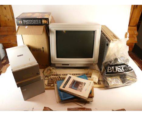 An Acorn A5000 modem, keyboard and monitor, with a selection of floppy discs, CD Rom games and associated accessories.