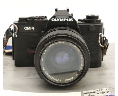An Olympus OM4 film camera, with a Zuiko f/4 35-70mm lens, in leather case.