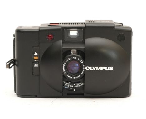 An Olympus XA 2 compact rangefinder film camera. 