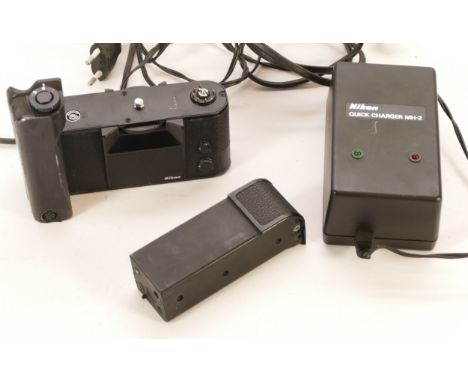 Three camera accessories; a Nikon Quick Charger MH-2, a Nikon Ni-Cd Battery Unit MN-2, and a Nikon Motor Drive MD-4, no. 1712