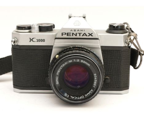An Asahi Pentax K1000 film camera, with Pentax-M f/2 50mm lens.