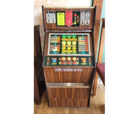 A 1970s Carfield 'Track Down' coin operated fruit machine, accepting 5/10/50 pence pieces, H157, W69, D56cm.