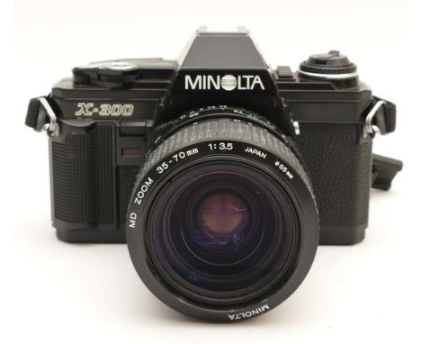 A Minolta X-300 film camera, with a Minolta f/3.5 35-70mm lens.