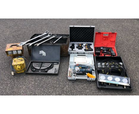A boxed Bosch GST 60PBE 110v 550w jigsaw, a 110v power pack, a boxed MacAllister 14.4v COD144CHDA hammer drill with two batte