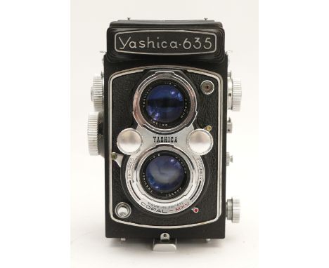 A Yashica 635 TLR camera, with two Yashikor f/3.5 80mm lenses, stamped SX 4102037, in leather travel case.