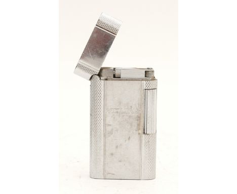 A Zippo pocket cigarette lighter, chrome plated with engine turned decoration, gas operated, boxed with operating instruction