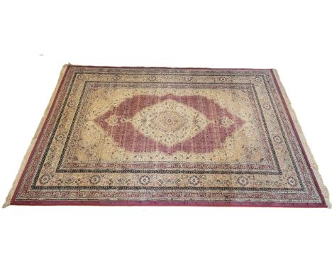 An early 20th century Persian style wool rug, beige and red central floral medallions, decorated along the borders with geome