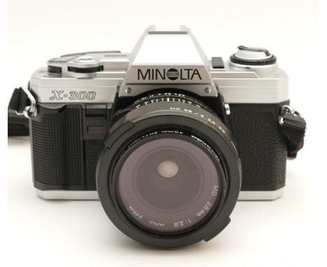 A Minolta X-300 film camera, with a Minolta f/2.8 28mm lens.