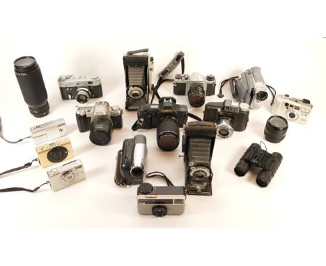 A collection of cameras and camera accessories, to include, Pentax MZ-50, Canon IXUS II, and Canon FD f/5.6 100-300mm lens. (