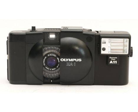 An Olympus XA 1 compact point and shoot film camera. 