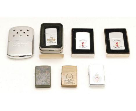 A collection of six Zippo cigarette lighters, cased and loose, together with a Zippo hand warmer.