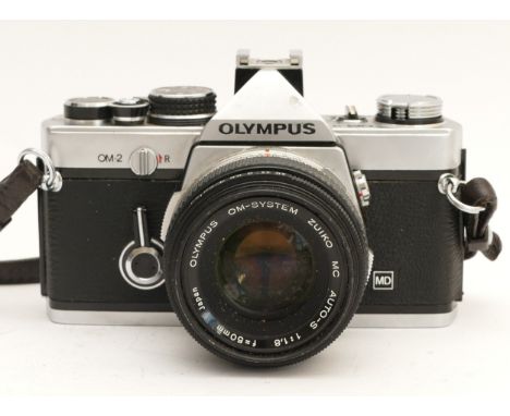 An Olympus OM2 film camera, with a Zuiko f/1.8 50mm lens, in leather case.