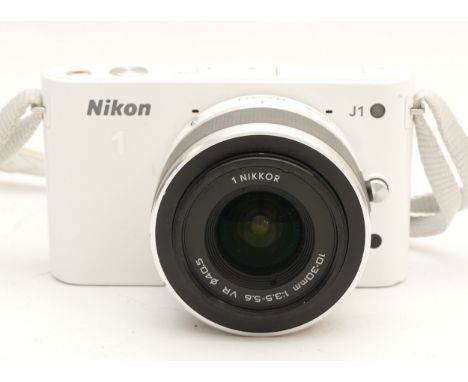 A Nikon J1 digital camera, with a Nikkor f/3.5-5.6 10-30mm lens, in white.