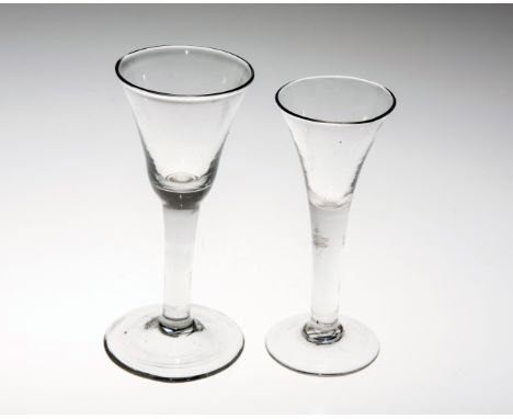 AN 18th CENTURY GLASS WINE FLUTE, with drawn trumpet bowl raised on a domed foot; together with A WINE GLASS OF SIMILAR DATE.