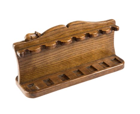 A ROBERT "MOUSEMAN" THOMPSON OAK PIPE RACK, the scrolled pediment with carved mouse signature. 17cm by 32cm 