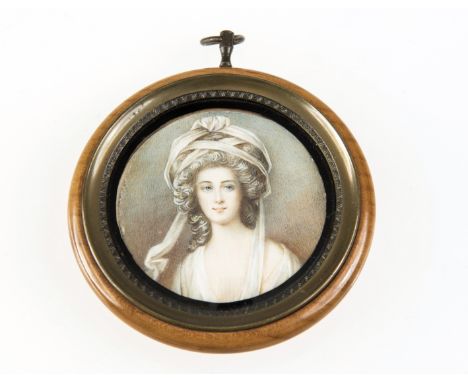 A PORTRAIT MINIATURE OF A LADY WITH ELABORATELY DRESSED HAIR, early 20th century, watercolour on ivory, circular in a wooden 