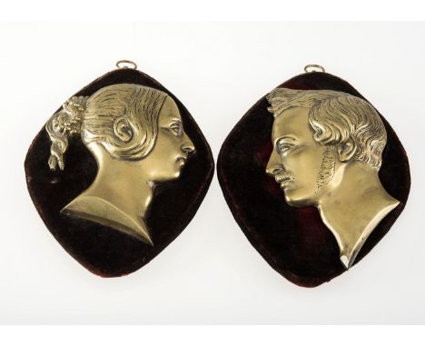 A PAIR OF MID-19th CENTURY BRASS PORTRAIT RELIEFS OF QUEEN VICTORIA AND PRINCE ALBERT, possibly a souvenir of their marriage,
