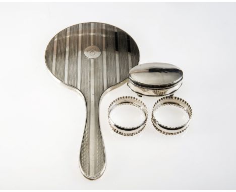 A GROUP OF SILVER COMPRISING: an oval ring box (marks rubbed); a pair of napkin rings, Birmingham 1918; and a hand mirror wit