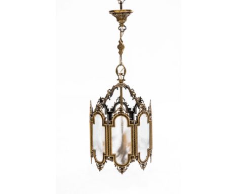 A GILT-BRASS THREE-LIGHT HANGING LANTERN, of octagonal form, the frosted glass panels within bead and scroll cast frames encl