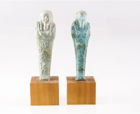 AN EGYPTIAN MIDDLE PERIOD USHABTI FIGURE, turquoise glazed earthenware, raised on a square section wooden stand; together wit