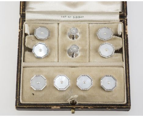 A CASED 9ct GOLD AND MOTHER OF PEARL GENTLEMAN'S DRESS STUD SET, c.1930, cufflinks, studs and collar studs, each centred by a