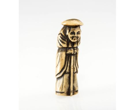 AN 18th/19th CENTURY JAPANESE CARVED ANTLER BONE NETSUKE OF A GENTLEMAN, possibly a Dutchman wearing a hat and holding a staf