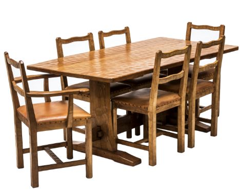 A DEREK FISHMAN SLATER OAK DINING SUITE, c.1970, comprising a 5 1/2ft dining table, of refectory form, the adzed rectangular 