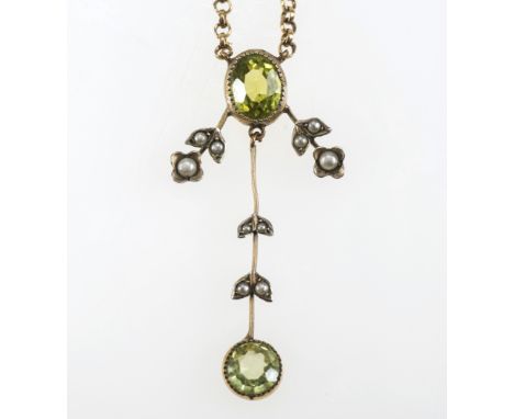 A PERIDOT AND SEED PEARL PENDANT IN THE EDWARDIAN TASTE, mounted with two collet-set peridots and leaf-set seed pearls, on a 