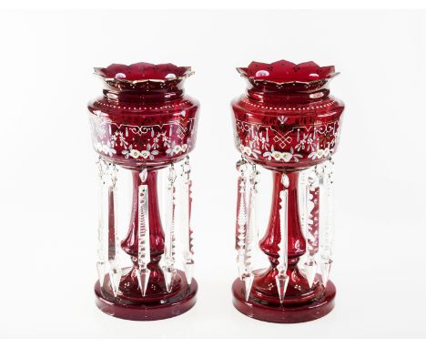 A PAIR OF VICTORIAN ENAMEL PAINTED RUBY GLASS LUSTRES, each with crenellated rim, painted with floral sprays and suspending p