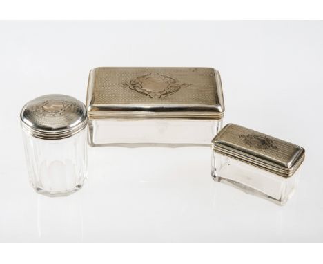 THREE CONTINENTAL SILVER-TOPPED GLASS DRESSING TABLE JARS, c.1900, possibly Russian, each with engine turned cover and vacant