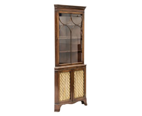 A GLAZED MAHOGANY STANDING CORNER CUPBOARD IN GEORGIAN STYLE, the upper section with a dentilled and moulded cornice over a g