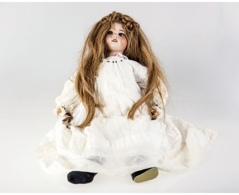 A S.F.B.J. BISQUE HEAD DOLL with blue glass sleeping eyes, open mouth showing teeth, long light brown hair, impressed S.F.B.J