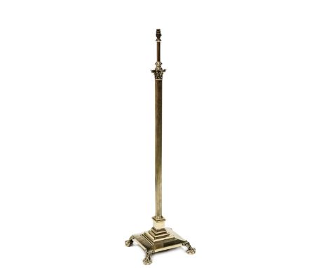 A BRASS COLUMNAR STANDARD LAMP, with Corinthian capital and reeded standard on a stepped square plinth raised on four ball an