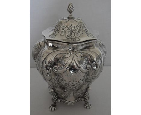 A Victorian silver tea caddy, Chester 1896, mark of George Nathan & Ridley Hayes, of bombe form, the hinged lid decorated wit