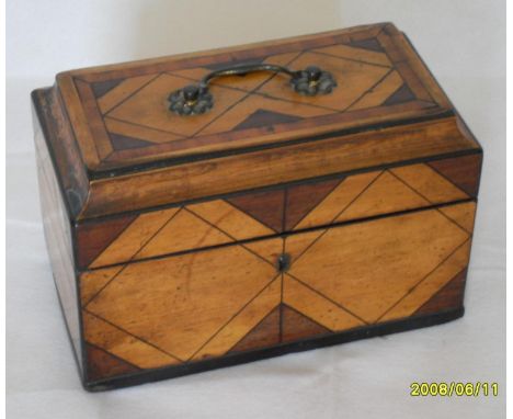 A Regency rectangular tea caddy composed of contrasting mahogany and satinwood with string inlay creating isometric designs, 