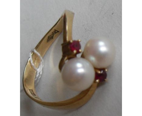 A stone set dress ring comprising two half-drilled akoya cultured pearl beads measuring 5.4mm diameter, peg-set to yellow mou