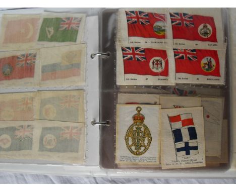 A collection in two albums of BDV silk cigarette badges and emblems to include 42 British Army regimental, 110 flags, approx.