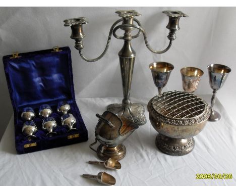 An assortment of silver plated table ware comprising a cased set of six coffee spoons, a two-branch candelabra, three goblets