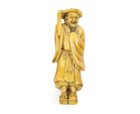 A Japanese Ivory Netsuke, Edo period, standing holding a lotus leaf on his head, wearing getas on his feet, 7.5cm high  Prove