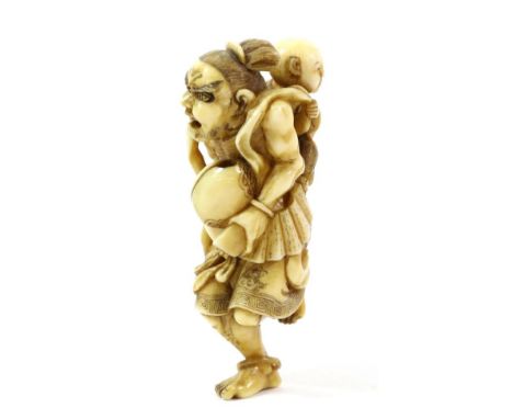 A Japanese Ivory Netsuke, Edo/Meiji period, as a Nio running carrying a child on his back, 7cm high  Provenance: David Bowden