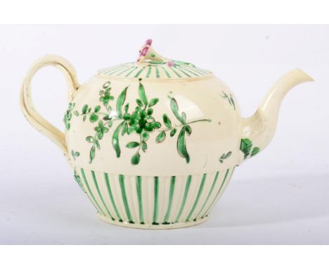 A Leeds Creamware Teapot and Cover, circa 1780, painted in green monochrome with stylised foliage within engine turned border