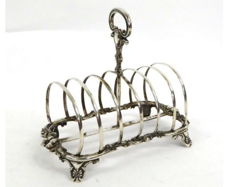 A Victorian Silver Toast Rack, Henry Wilkinson &amp; Co, Sheffield 1851, the scrolling foliate frame on decorative bracket fe