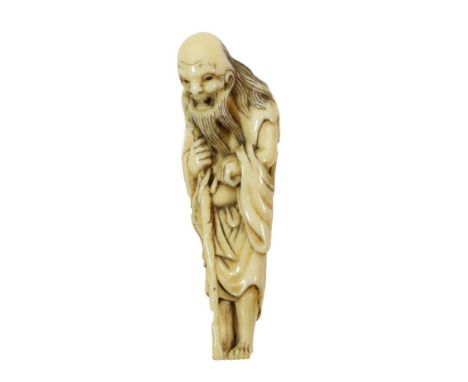 A Japanese Ivory Netsuke, Edo period, as a Sennin leaning on a staff, 8cm highSome staining and minor surface splitting. 